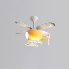 a white ceiling fan with yellow and white blades hanging from it's center blade