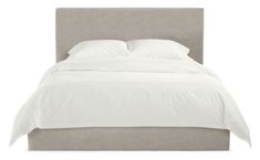 a bed with white sheets and pillows on it's headboard, against a white background