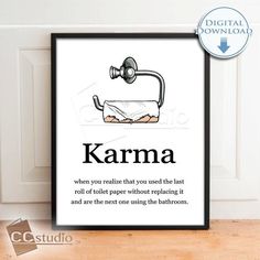 a framed poster with the words karma written in black and white, on top of a wooden floor