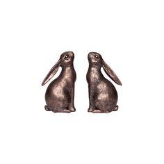 two metal rabbits sitting next to each other