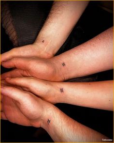 three people with matching tattoos on their arms