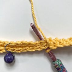 the crochet hook is hooked up to an object