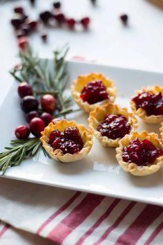 small tarts with cranberry sauce on a white plate