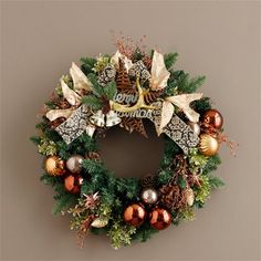 a christmas wreath hanging on the wall with ornaments and decorations around it's edges