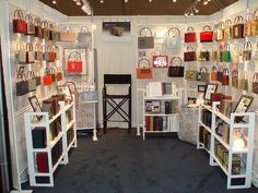 a room filled with lots of different types of purses and handbags on display