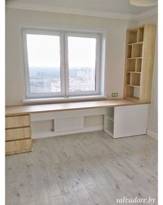 an empty room with two windows and a desk