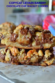 three cookies stacked on top of each other with chocolate chips and walnuts in the middle