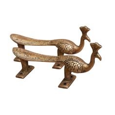 two metal birds sitting on top of each other