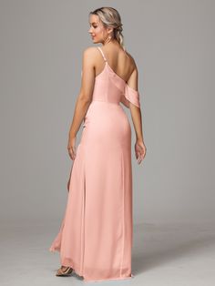 a woman in a long pink dress with one shoulder and open back, looking down at the