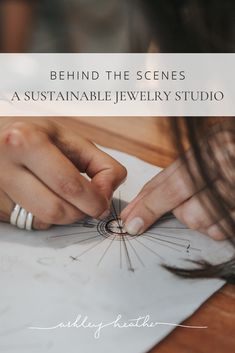 a woman is doing something on paper with the text behind her that reads, behind the scenes a suitable jewelry studio