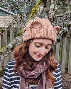 a woman wearing a knitted hat and scarf