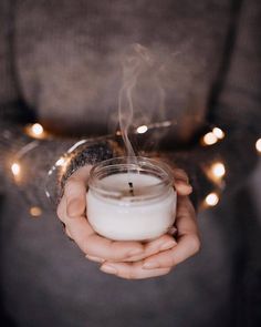 a person holding a candle in their hands