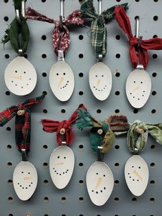 several spoons with different designs are hanging on a wall