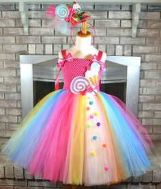 a dress made out of tulle with candy and lollipops on it