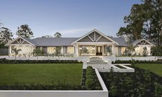 a large white house sitting on top of a lush green field