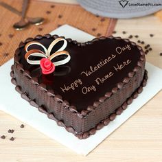 a heart shaped chocolate cake sitting on top of a table