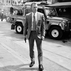 a man in a suit and tie walking down the street