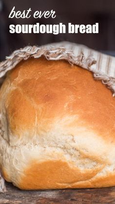 a loaf of sourdough bread sitting on top of a wooden table with the words best ever sourdough bread