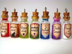 seven miniature bottles filled with different colored liquids