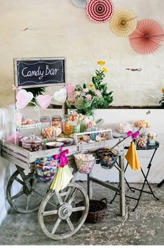 a candy bar with umbrellas hanging from the ceiling and decorations on the wall behind it