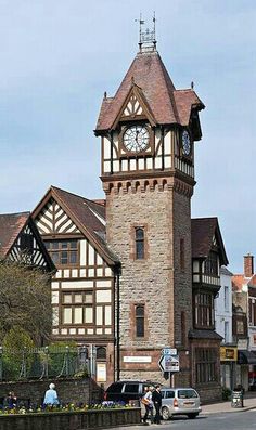 an old building with a clock tower on the side of it's front entrance