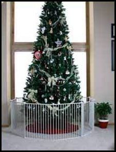 a christmas tree is in the corner of a room with a metal fence around it