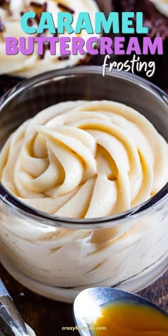 a bowl filled with cream sitting on top of a table next to some spoons