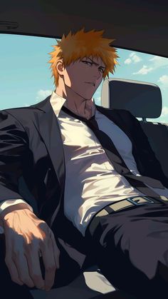 a man sitting in the back seat of a car with orange hair and white shirt