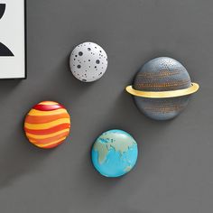 three different sized and shaped rocks sitting next to each other on a gray table top