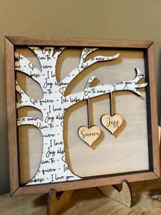 a family tree with two hearts hanging from it