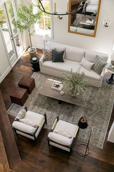 an aerial view of a living room with couches, chairs and a coffee table