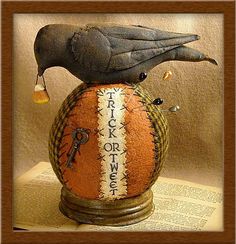 a bird is perched on top of an old ball with writing and keys in it