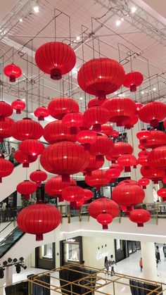 many red lanterns are hanging from the ceiling