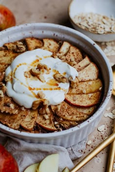 an apple crisp with yogurt and apples on the side