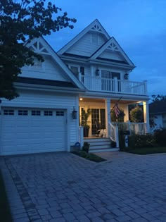 a large white house with an american flag on the porch