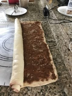 a long piece of bread sitting on top of a counter