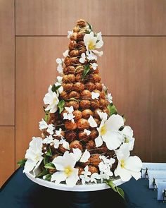 a tall cake with white flowers on top