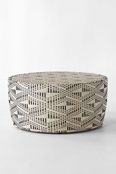 a black and white basket sitting on top of a table