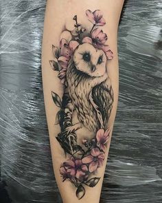 an owl and flowers tattoo on the leg