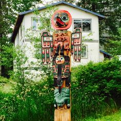 a totem pole in front of a house