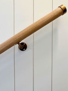 a wooden handle on a white painted wall