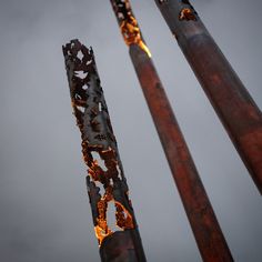 three skis are standing in the air with their lights on