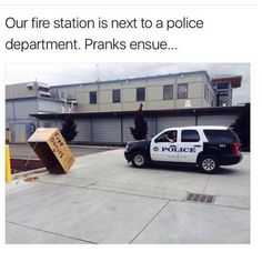 a police car parked in front of a building with a cardboard box on the back