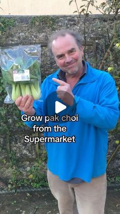 a man holding up some vegetables in his hand and pointing to it with the caption grow pak choi from the supermarket