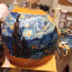 a pumpkin decorated with an image of the starry night