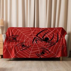 a couch covered in a red spider web blanket