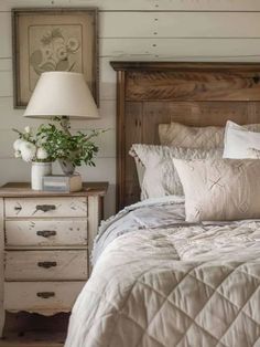 a bedroom with a bed, nightstands and lamp on the side table in front of it