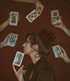 a woman surrounded by playing cards in her hands