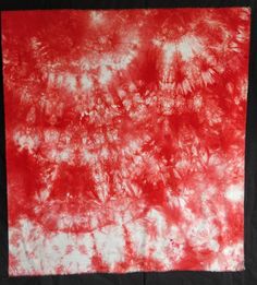 a red and white tie - dyed piece of cloth