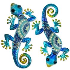 two blue and yellow geckos are standing next to each other on a white background